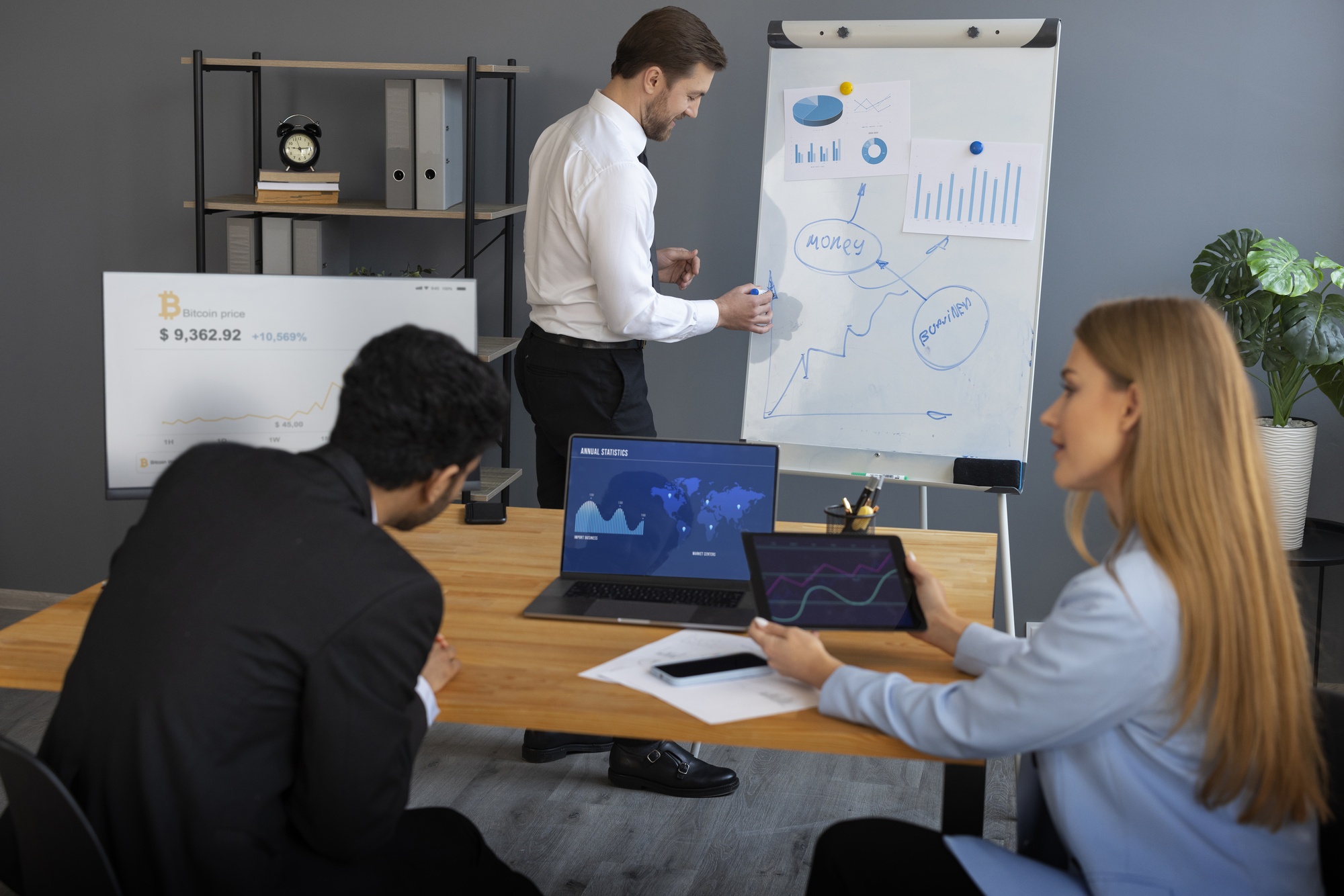 Analyst reviewing website audit data on a computer and creating a strategic marketing plan document